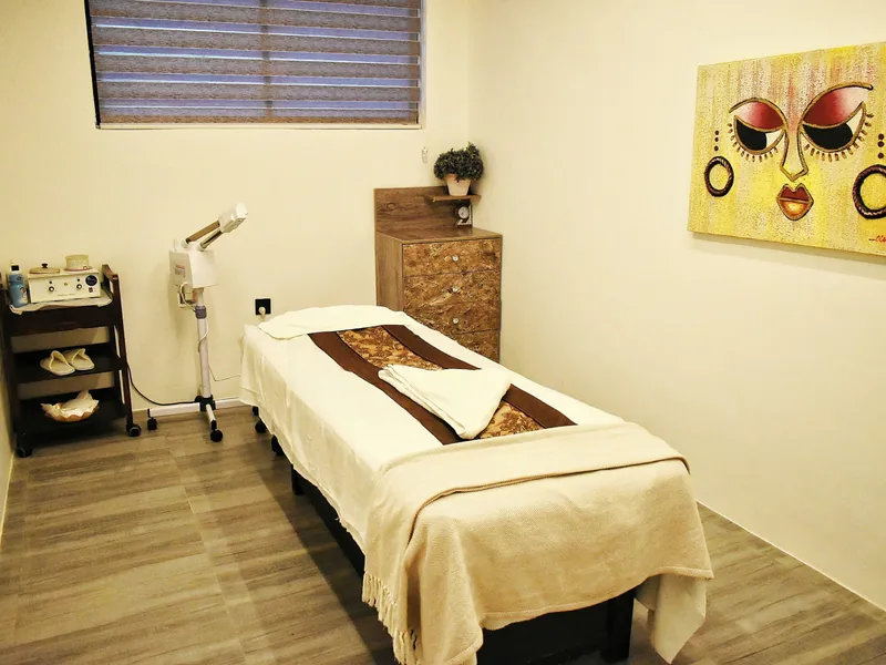 Massage and body treatment room with portrait artwork at Facial Bar, Victoria Island, Lagos